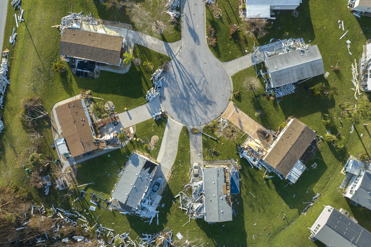 Property damage from strong hurricane winds. Mobile homes in Florida residential area with destroyed rooftops. Consequences of natural disaster.