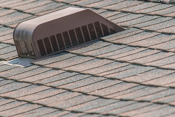Roof vent seated on shingles, a common leak point after storm damage