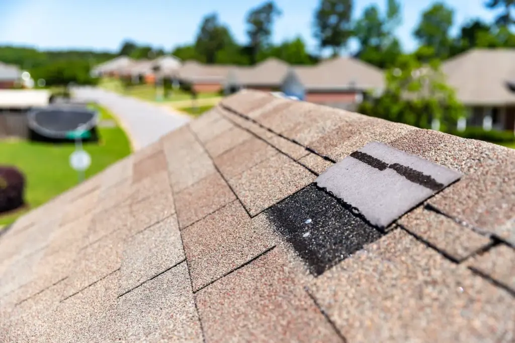 Shingle roof ridge with a repair patch along the peak
