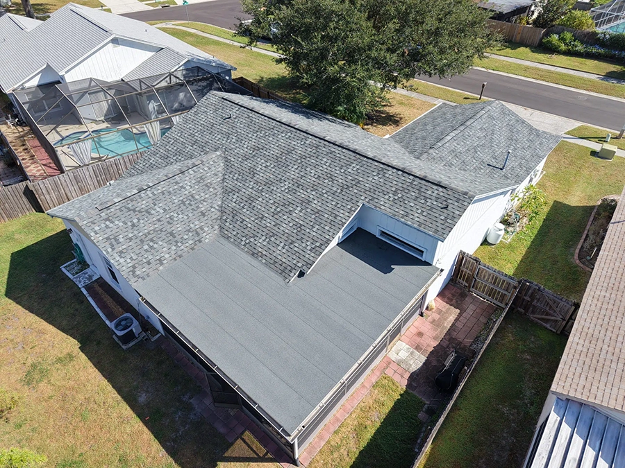 Aerial view of a completed asphalt shingle roof installation on a Florida home