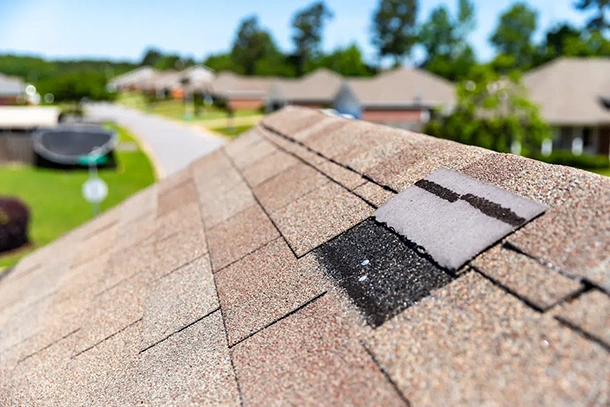 Shingle roof ridge with a repair patch along the peak